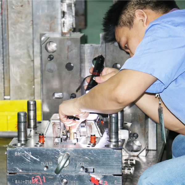 worker working on molding machine